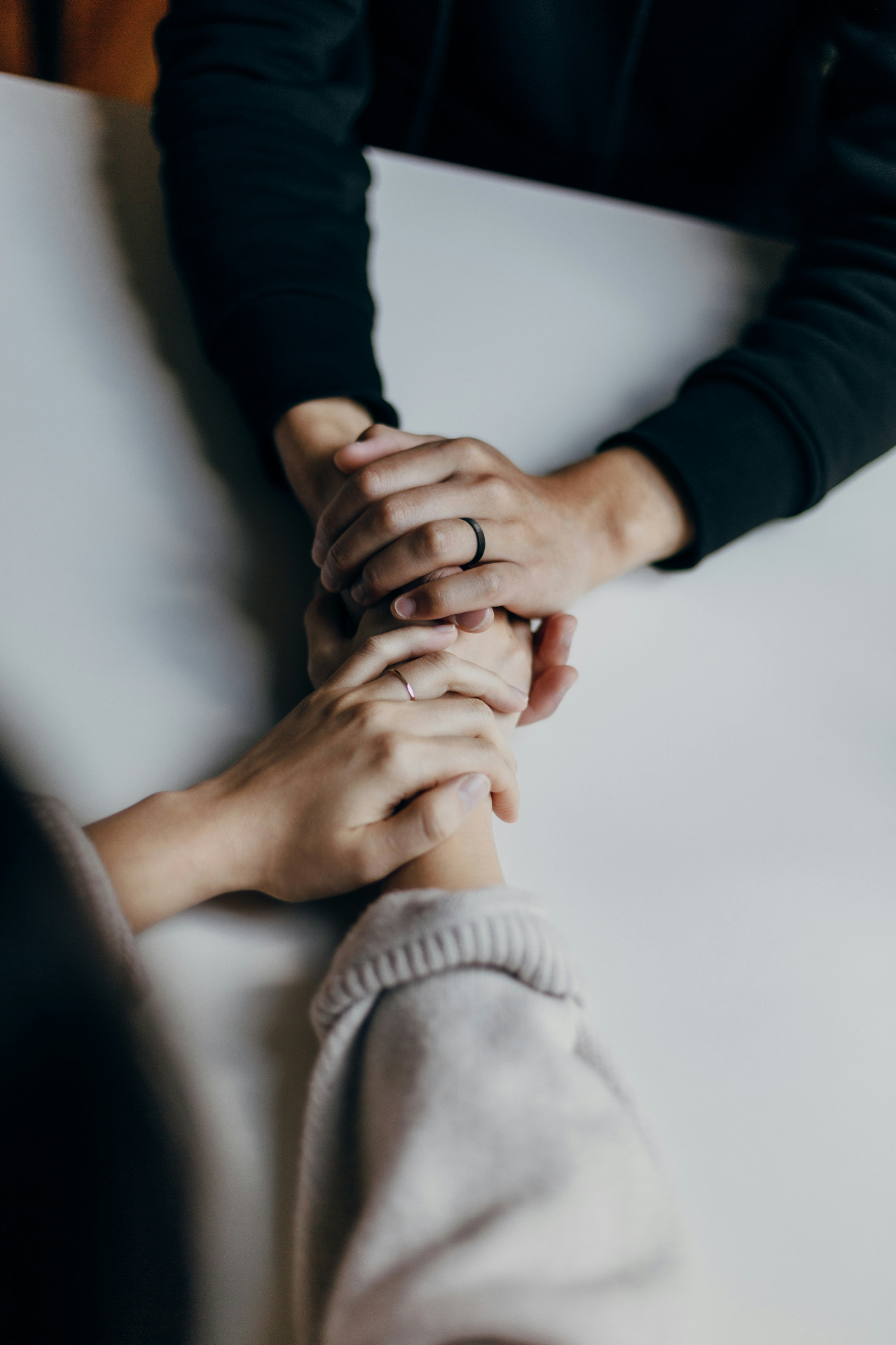 Caring hands holding each other, representing our compassionate approach